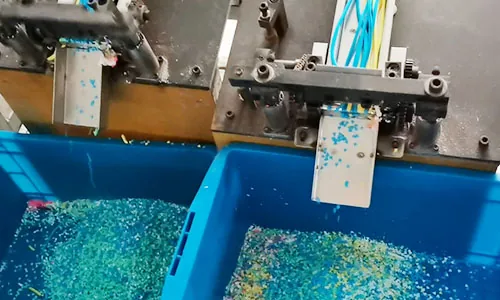 Machine slicing polymer clay into decorative pieces